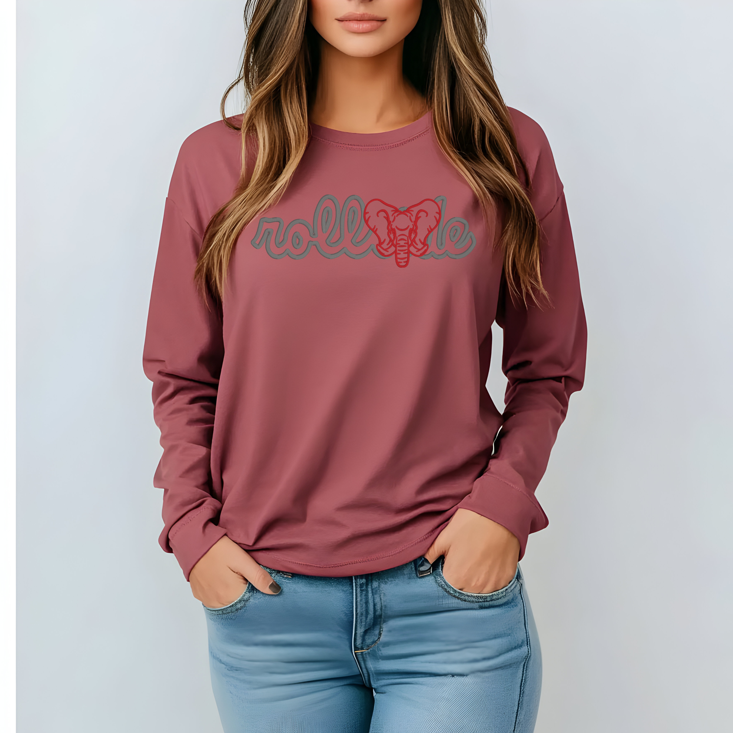 Person wearing a maroon long-sleeve shirt with 'roll Tide' text and elephant graphic, standing against a light background.