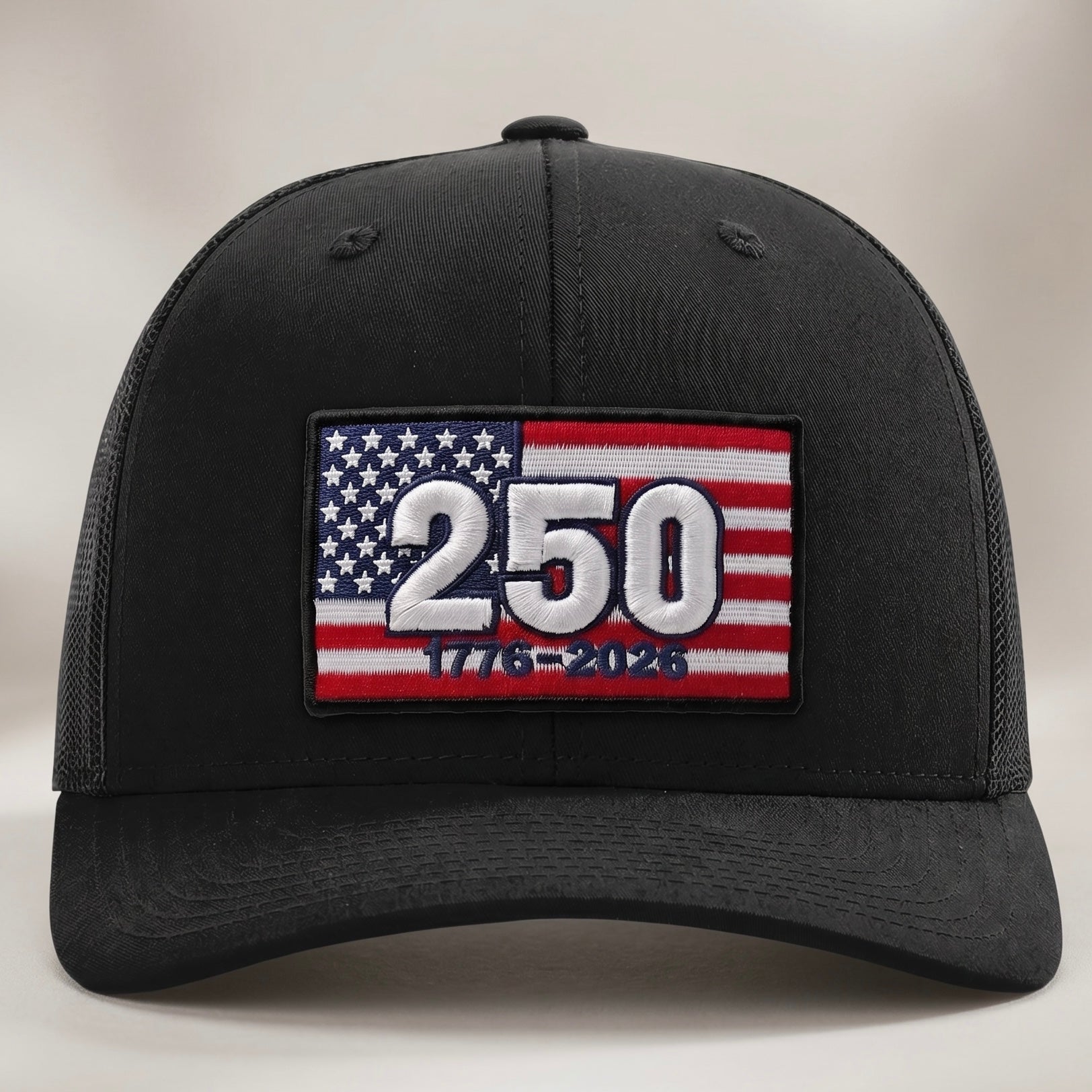 Black cap with American flag and number 250 patch on a light gray background