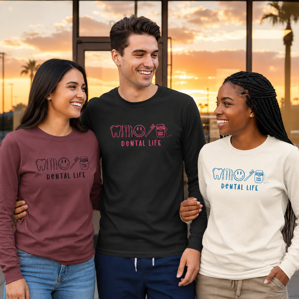 Three people wearing 'Dental Life' embroidered themed shirts standing together with a sunset in the background.