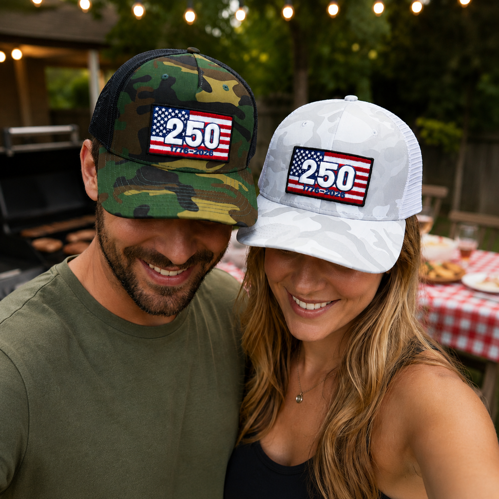 Two people wearing hats with '250' and American flag designs, standing outdoors.