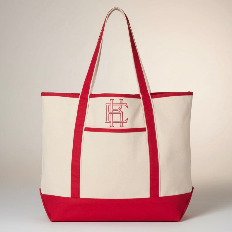 Red and canvas tote bag with a logo on a light beige background