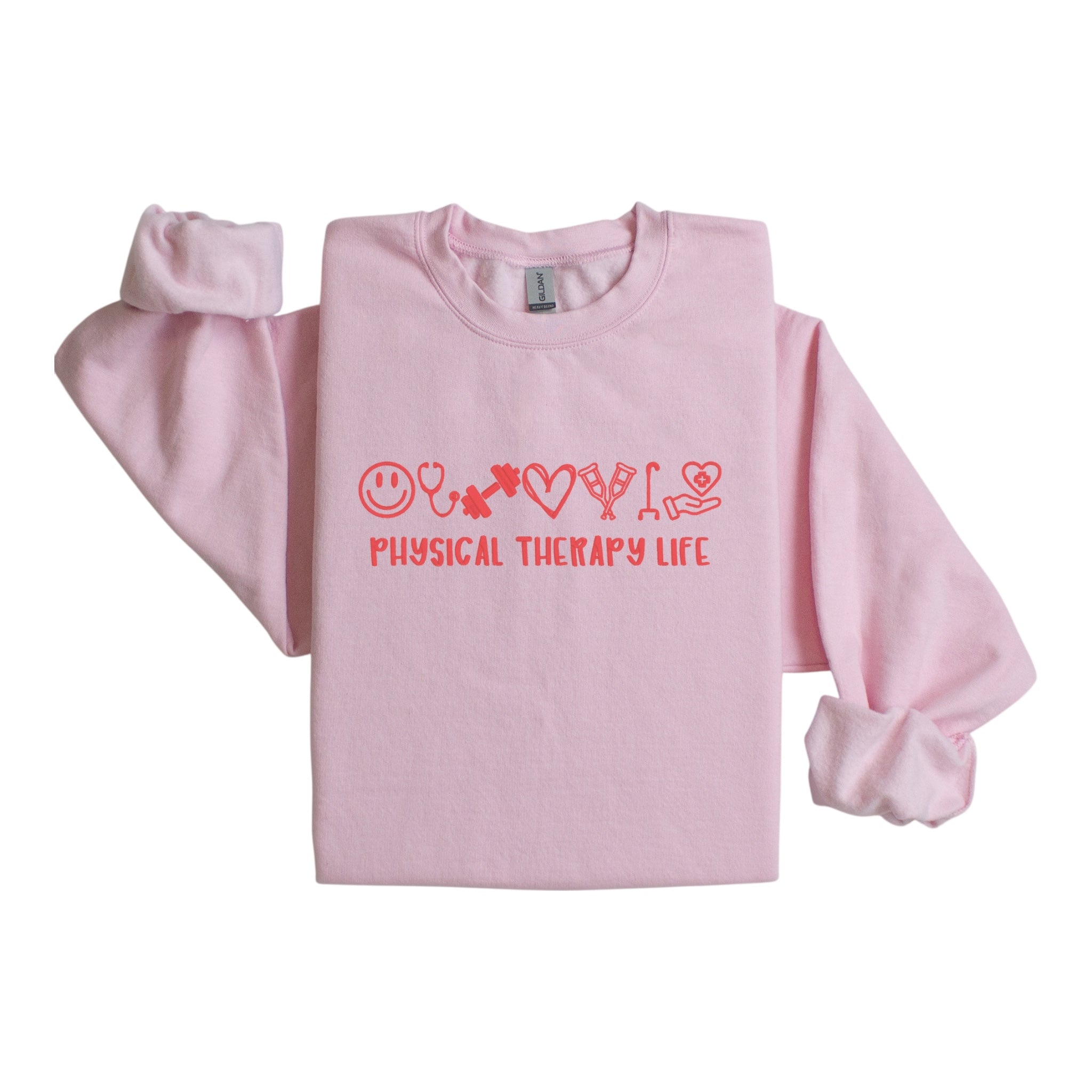 Pink sweatshirt with 'Physical Therapy Life' text and smiley face symbols on a white background