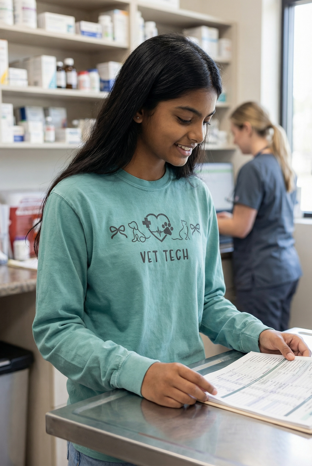 Person wearing a 'Vet Tech' shirt in a medical setting