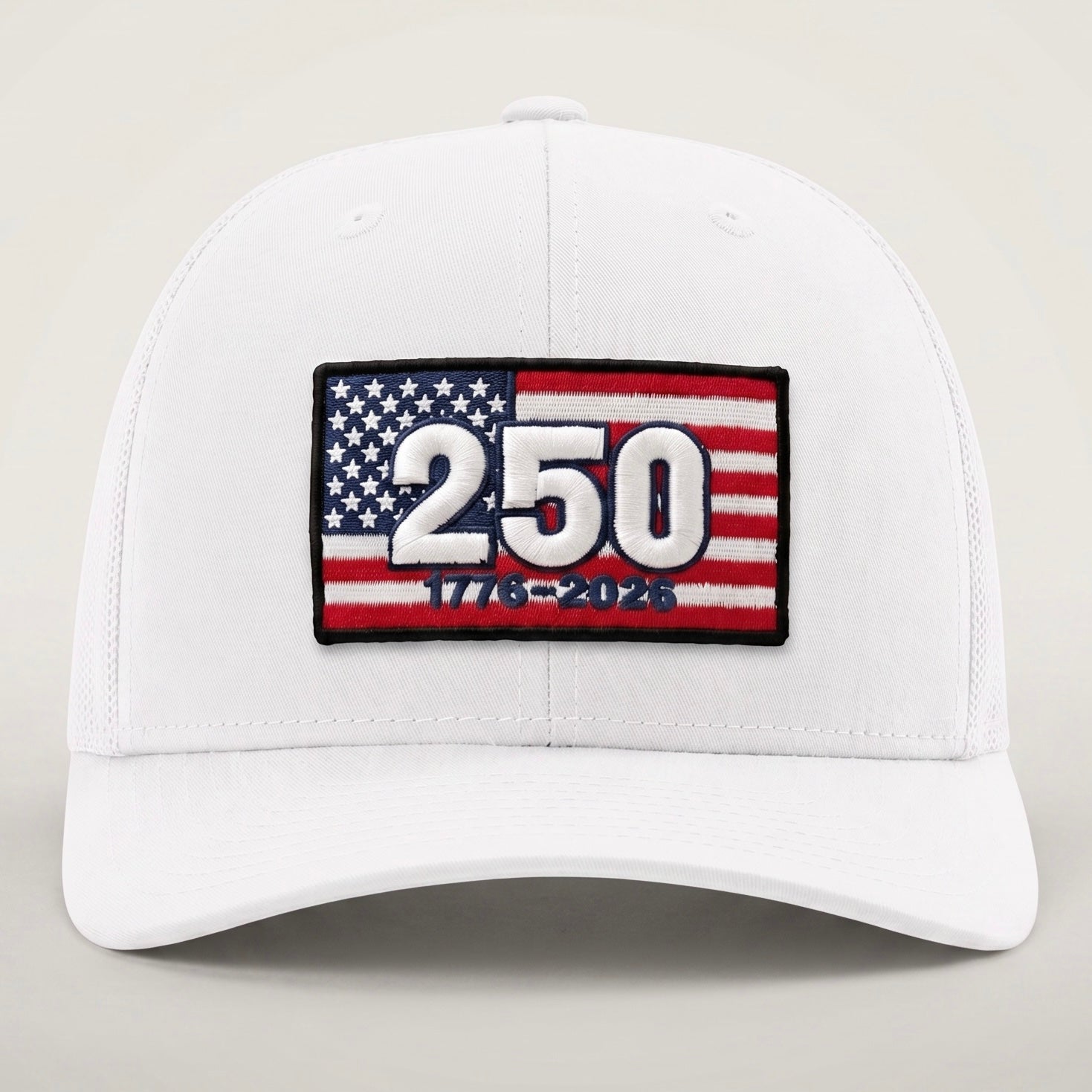 White cap with American flag patch celebrating 250 years on a neutral background