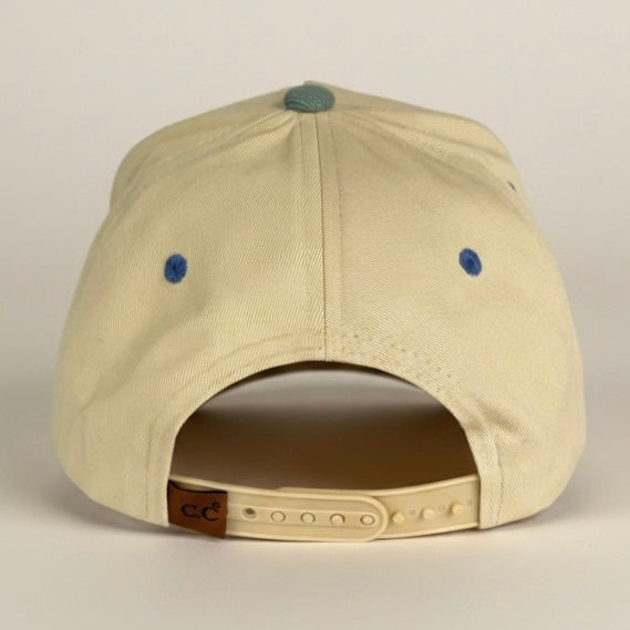 Beige cap with blue buttons on a beige background